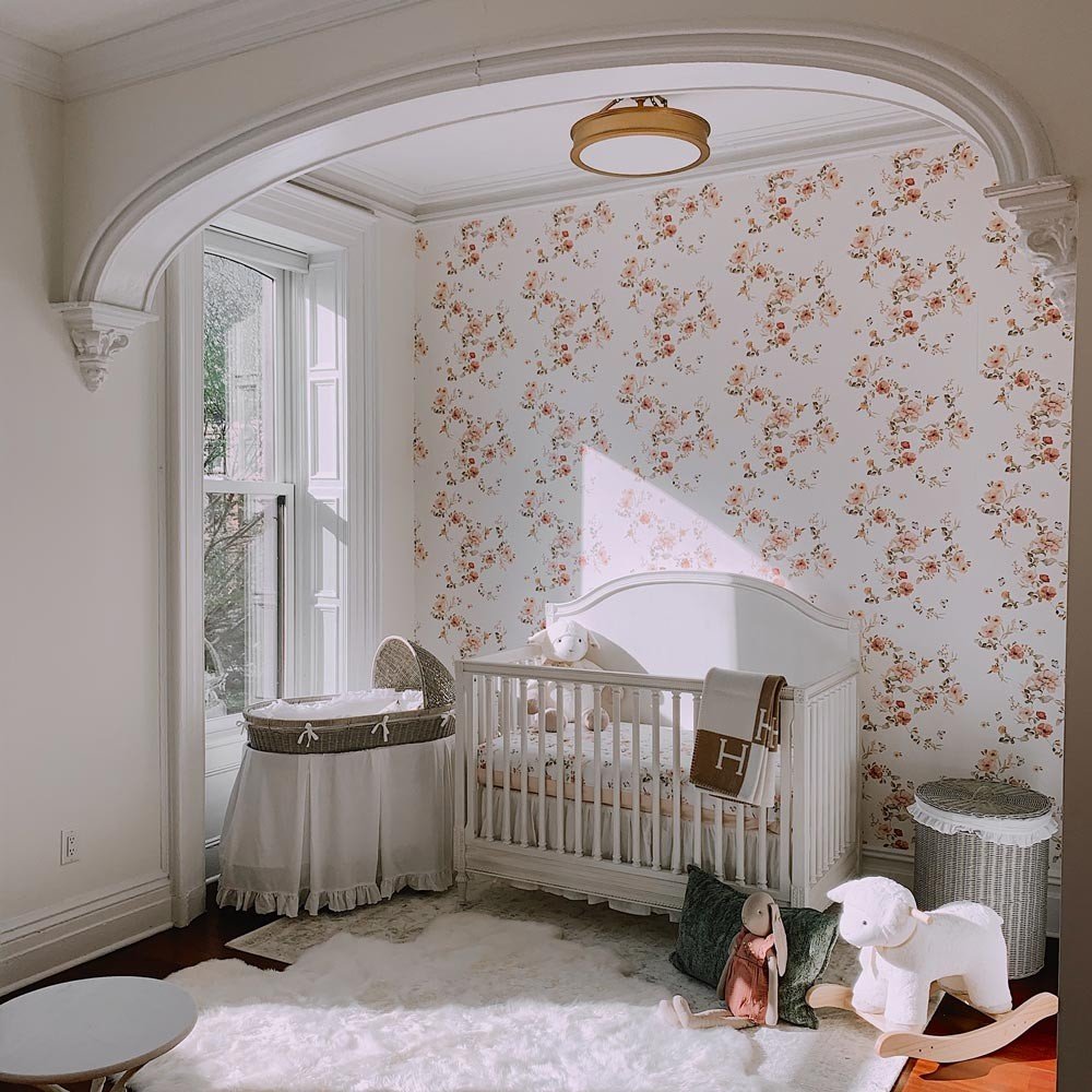 1. Nursery with floral vintage wallpaper, white crib, and plush toys creating a cozy atmosphere