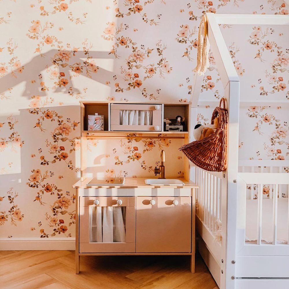 2. Children's room with floral vintage wallpaper, wooden play kitchen, and crib under warm lighting