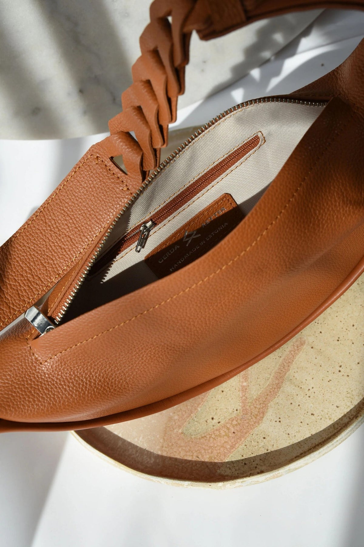 6. Interior view of caramel brown Flora Leather Bag by Gerda Retter Design, showing zipper pocket