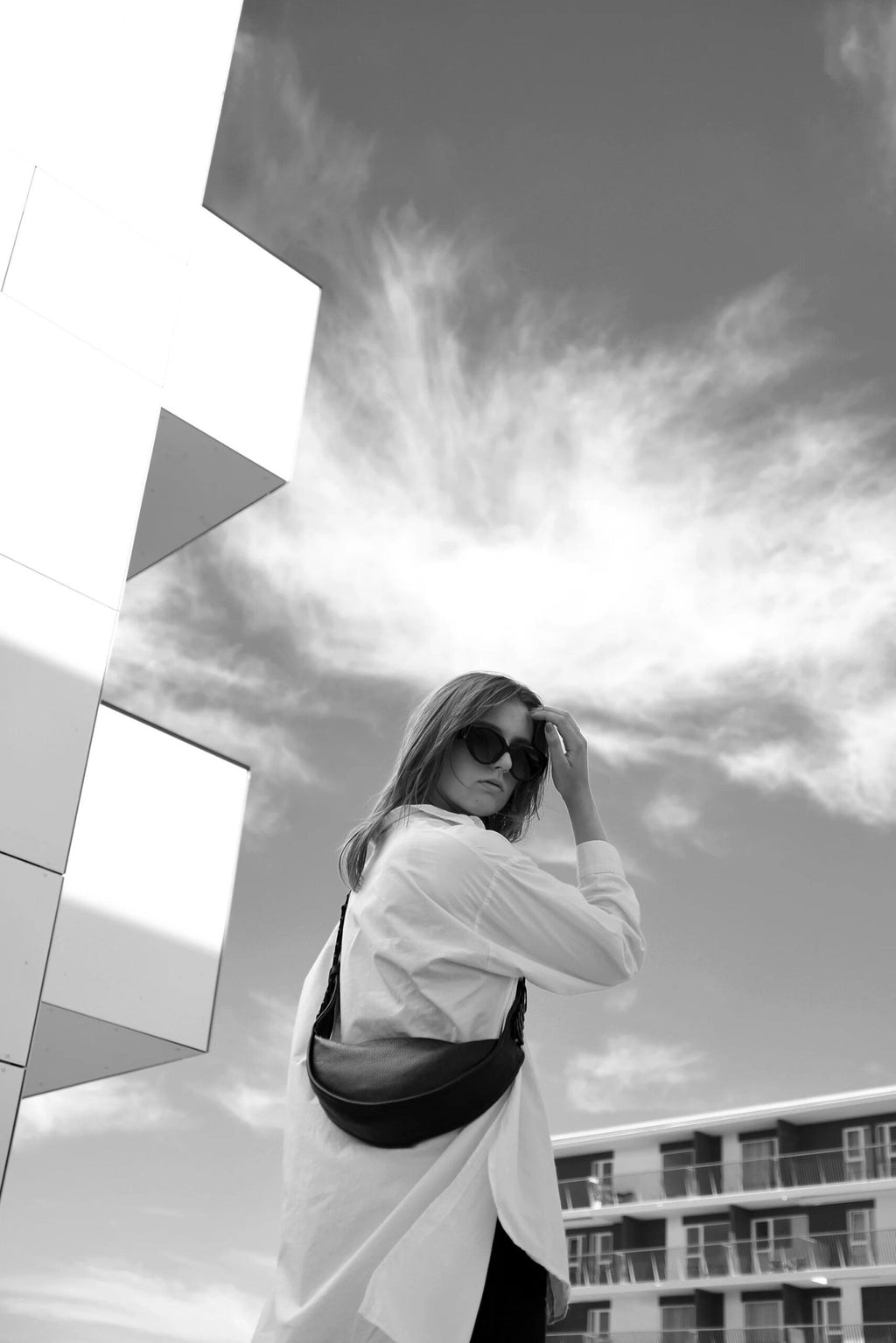 8. Black and white image of woman with black Flora Leather Bag by Gerda Retter Design, urban background