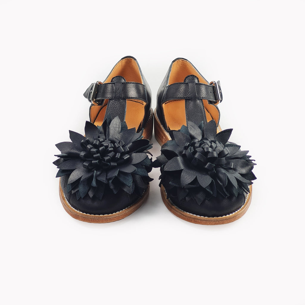 2. Studio shot of women's black leather fisherman sandals with flower embellishment, front view