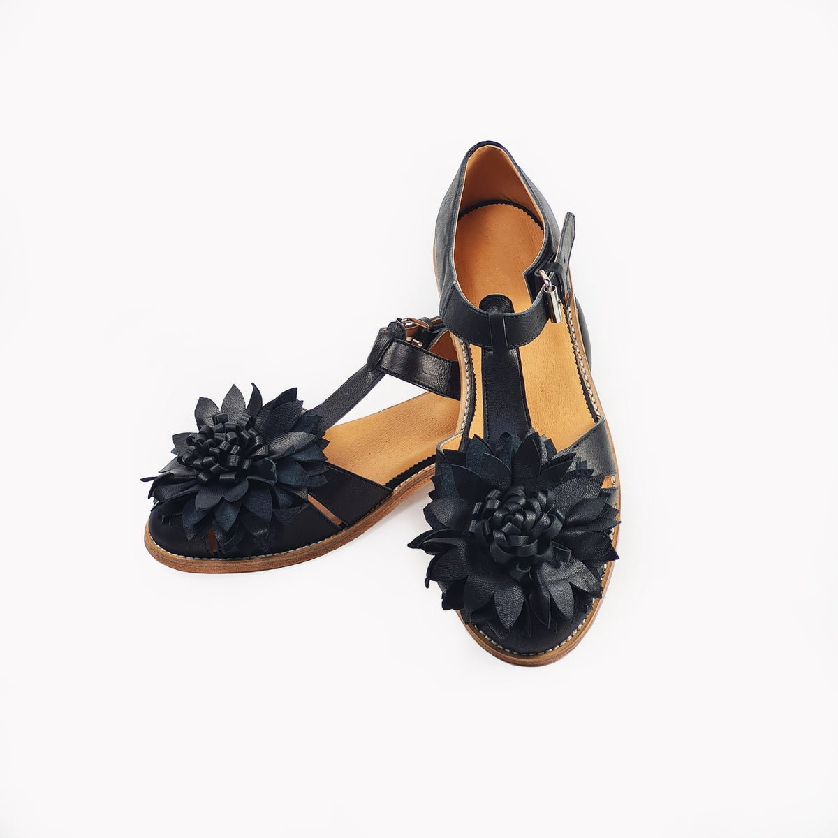 4. Top view of women's black leather fisherman sandals with flower embellishment