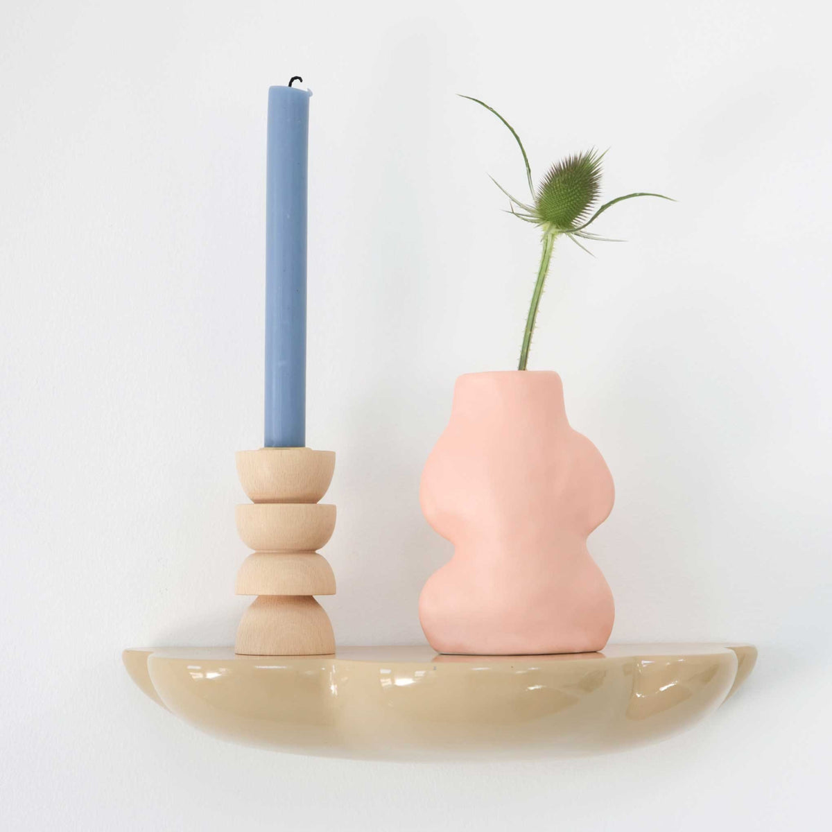 1. Fluxo Ceramic Vase Small in pink by 5mm Paper on a shelf with a blue candle, showcasing modern Portuguese craftsmanship