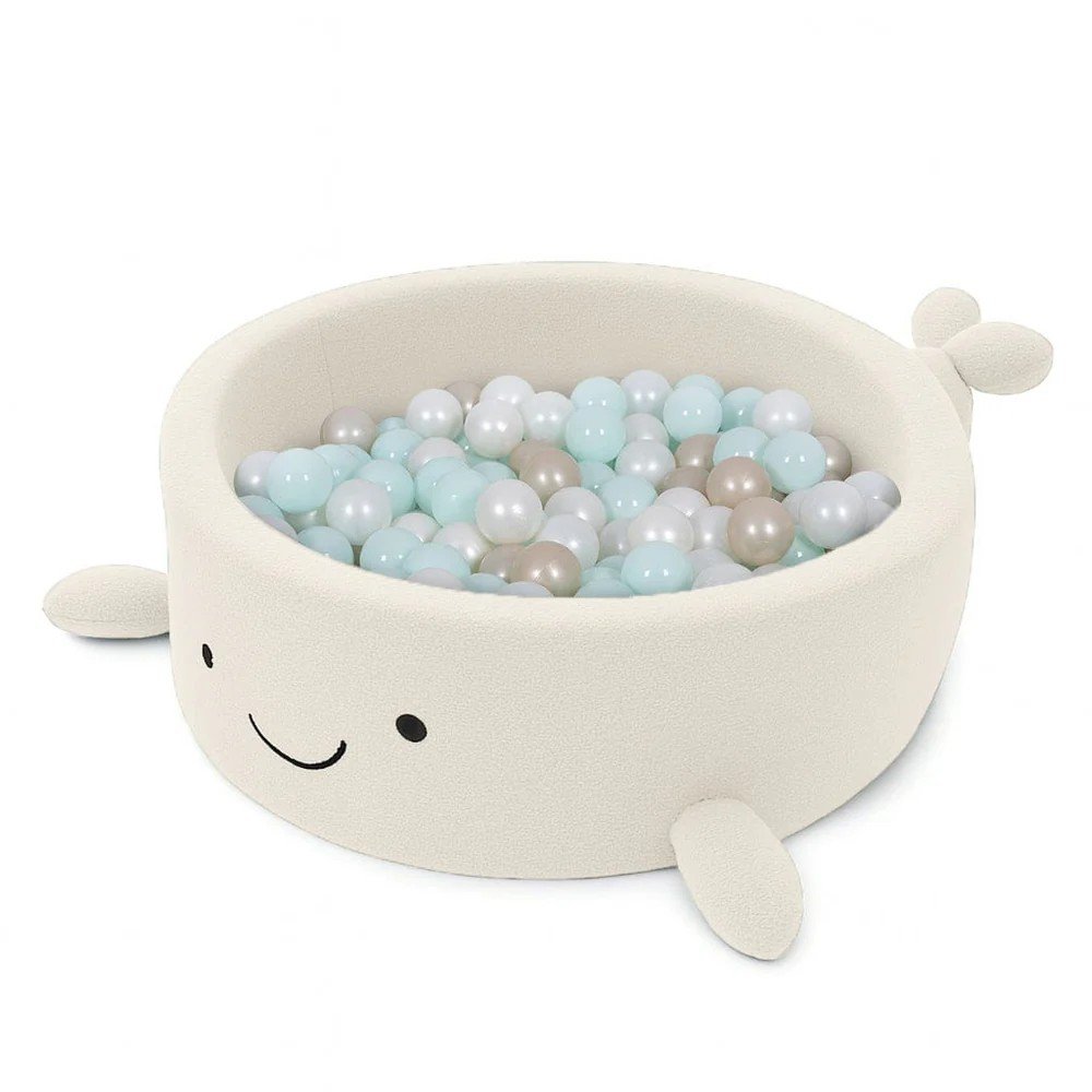 1. Whale-shaped baby ball pit in cream boucle fabric filled with pastel balls, featuring soft fins and a smiling face, designed for sensory play