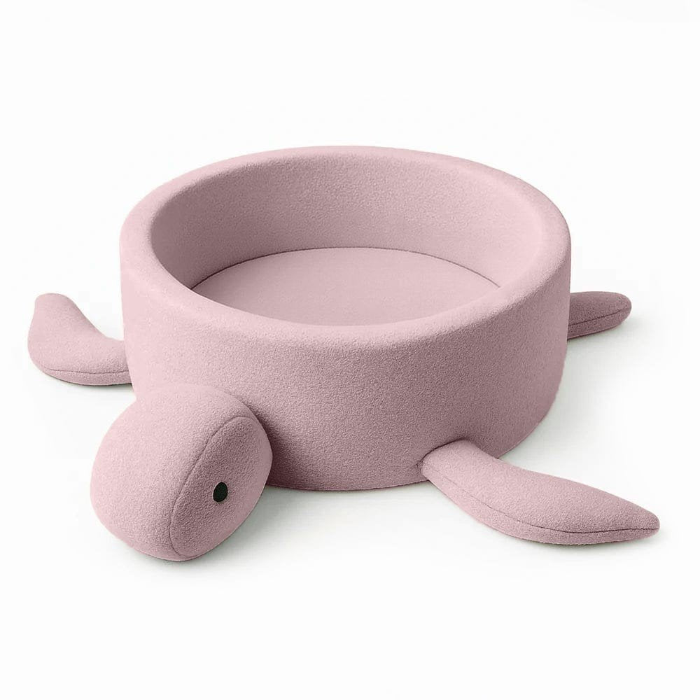 1. Turtle-shaped baby ball pit in raspberry glaze pink boucle fabric with soft fins, shown empty on a white background