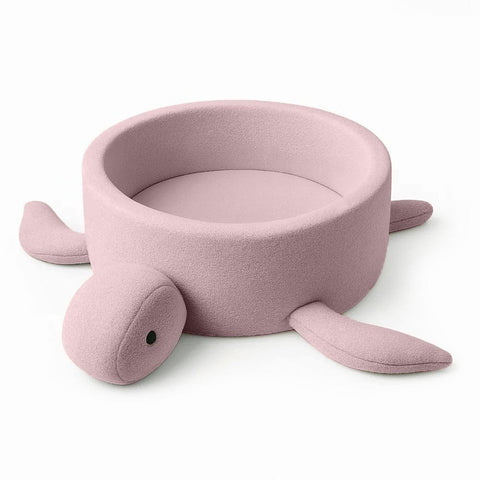 1. Turtle-shaped baby ball pit in raspberry glaze pink boucle fabric with soft fins, shown empty on a white background