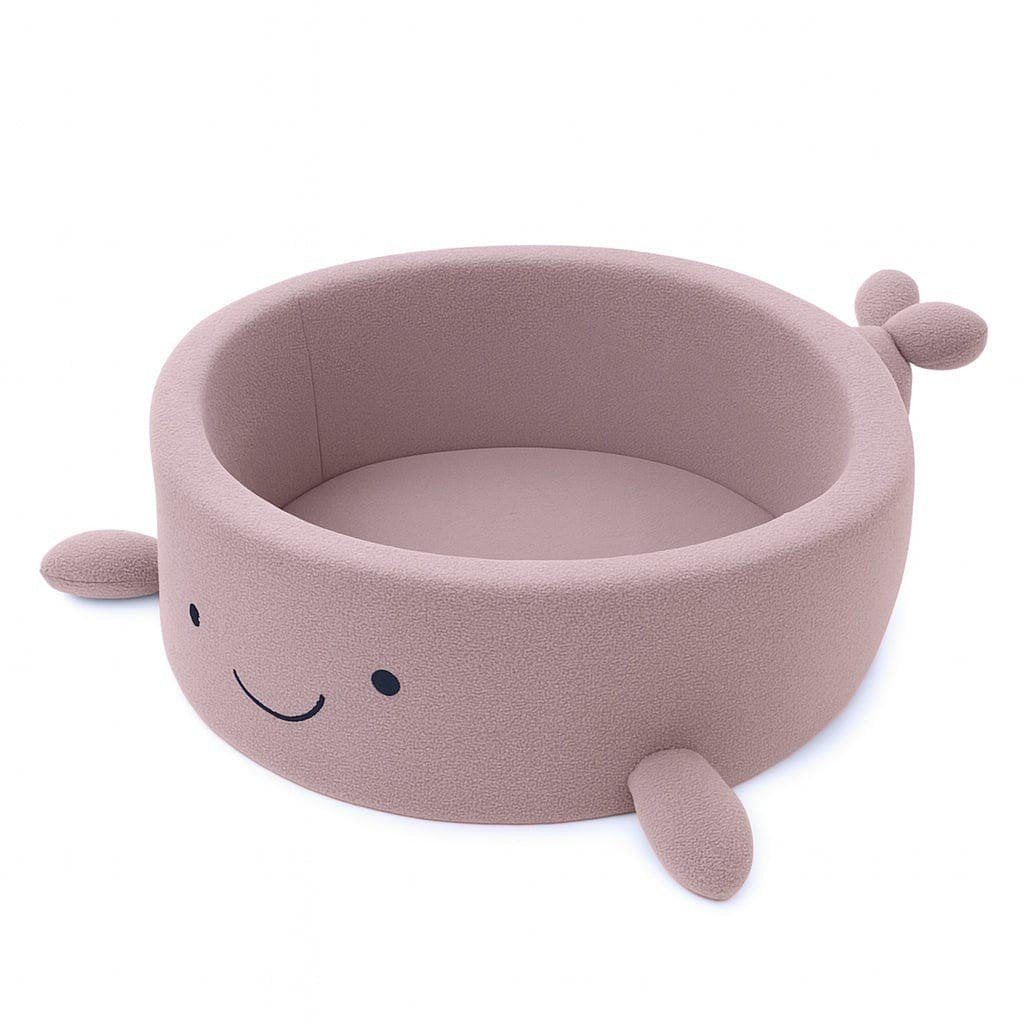 1. Whale-shaped baby ball pit in raspberry glaze pink boucle with soft fins and smiling face, shown empty