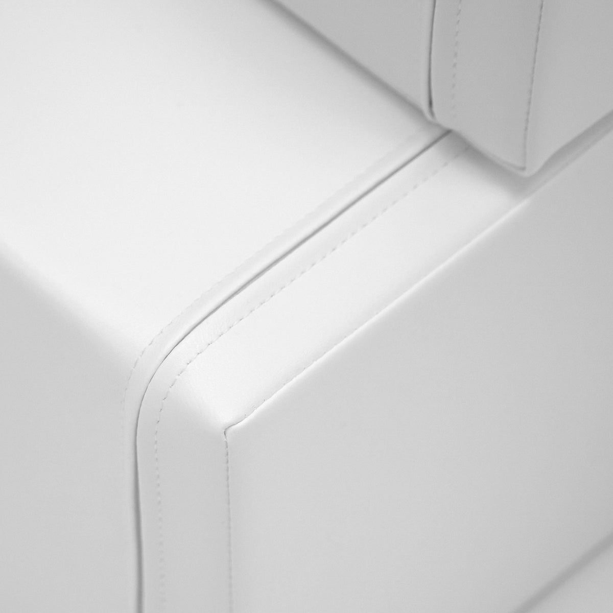 6. Close-up of white foam building block showing stitching detail on soft eco-leather cover
