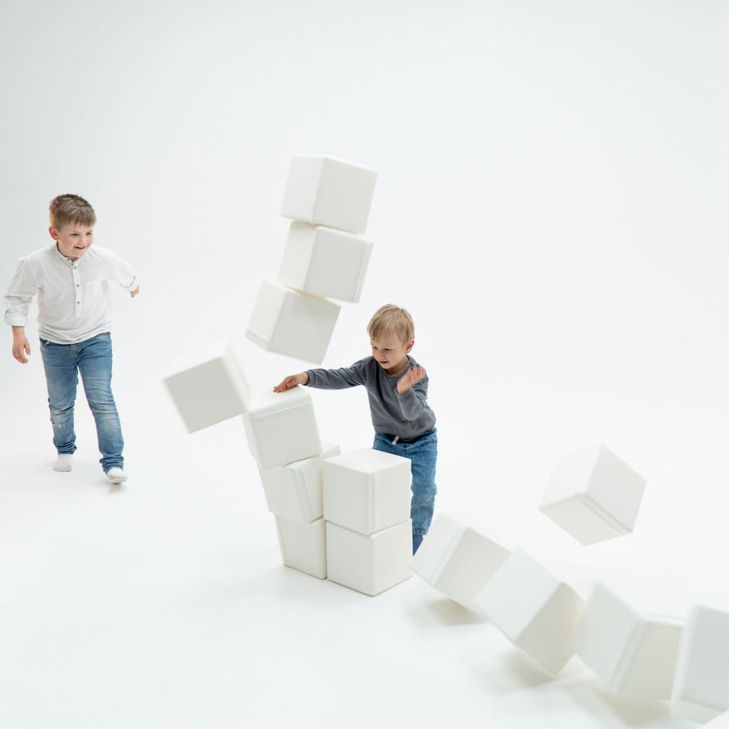 1. Two boys playing with ivory foam mega cube building blocks by IGLU in a bright room