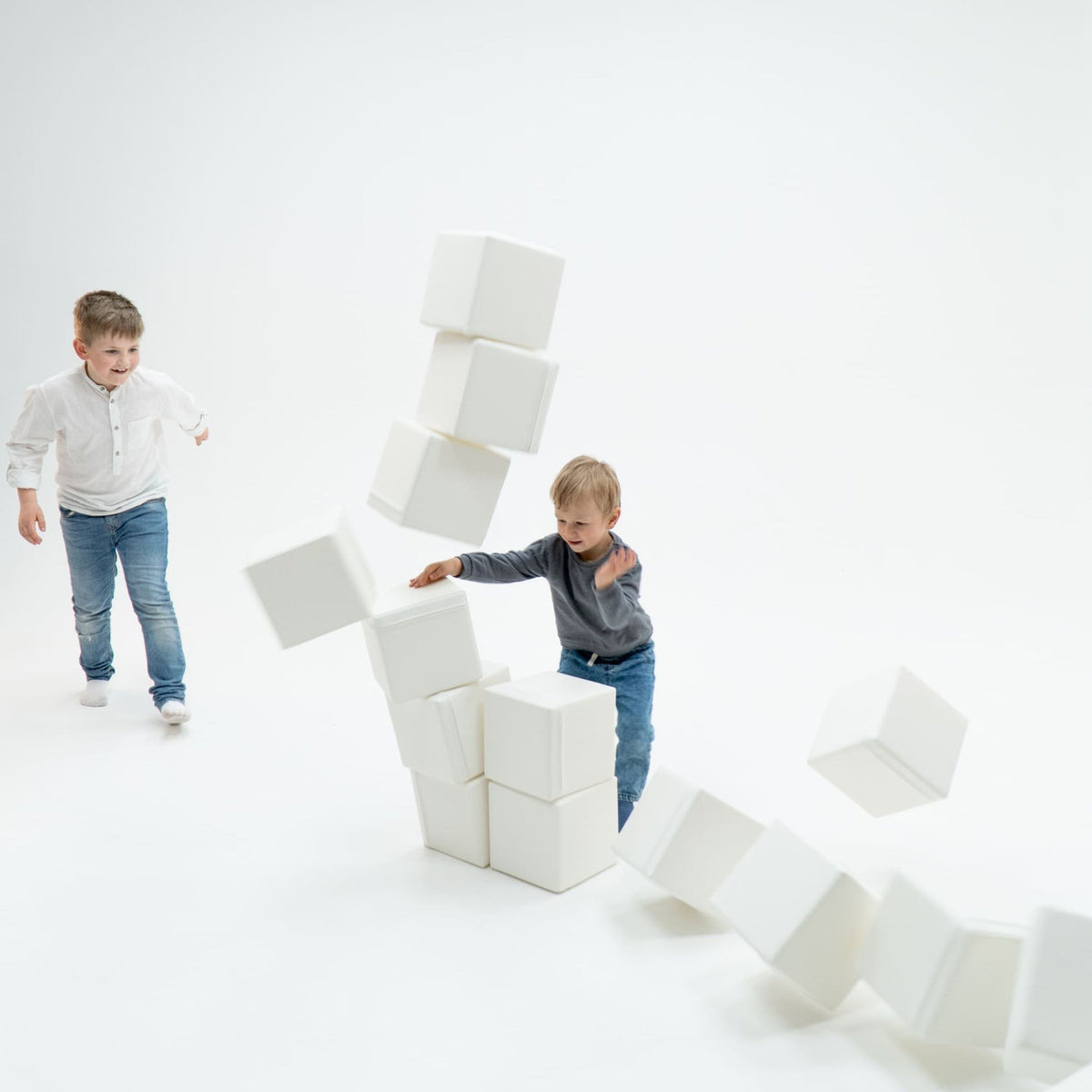1. Two boys playing with ivory foam mega cube building blocks by IGLU in a bright room