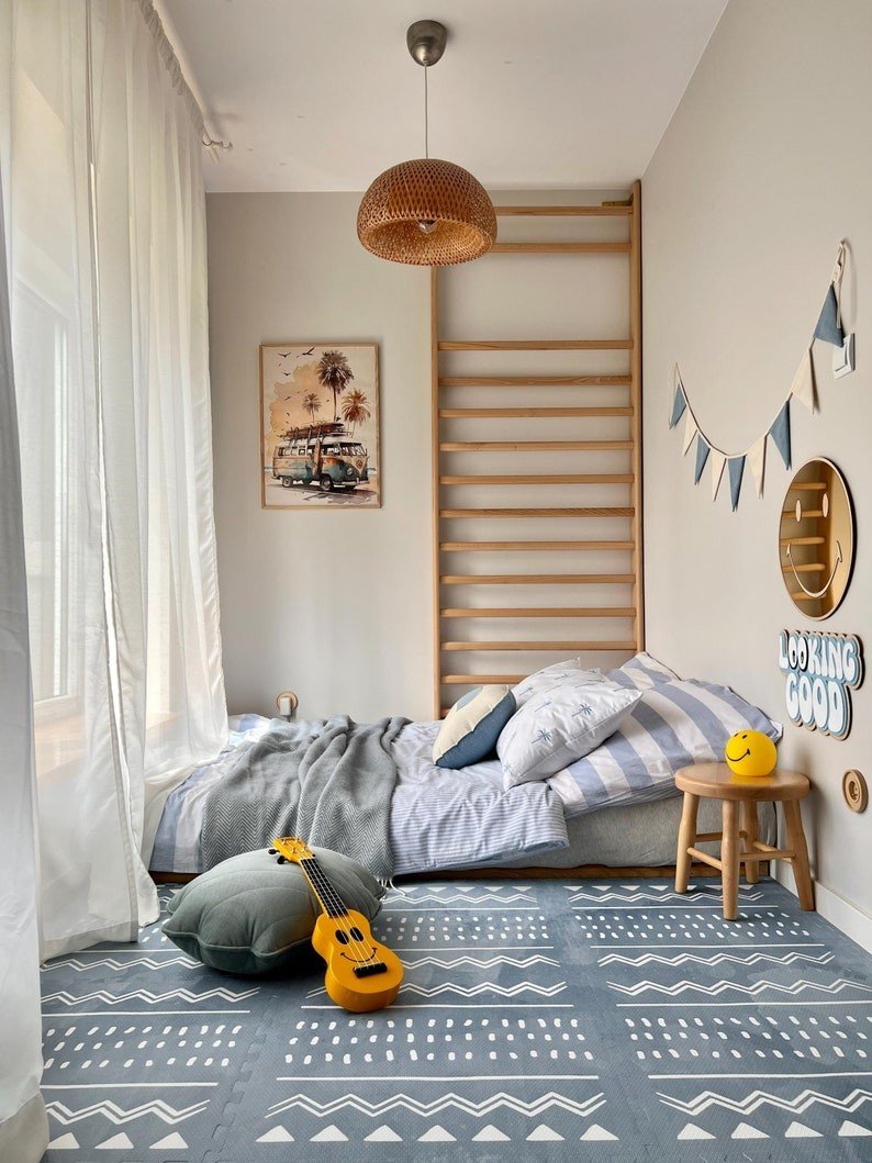 3. Blue OLYA KIDS Boho puzzle playmat in cozy bedroom with bed, pillows, and decorative items