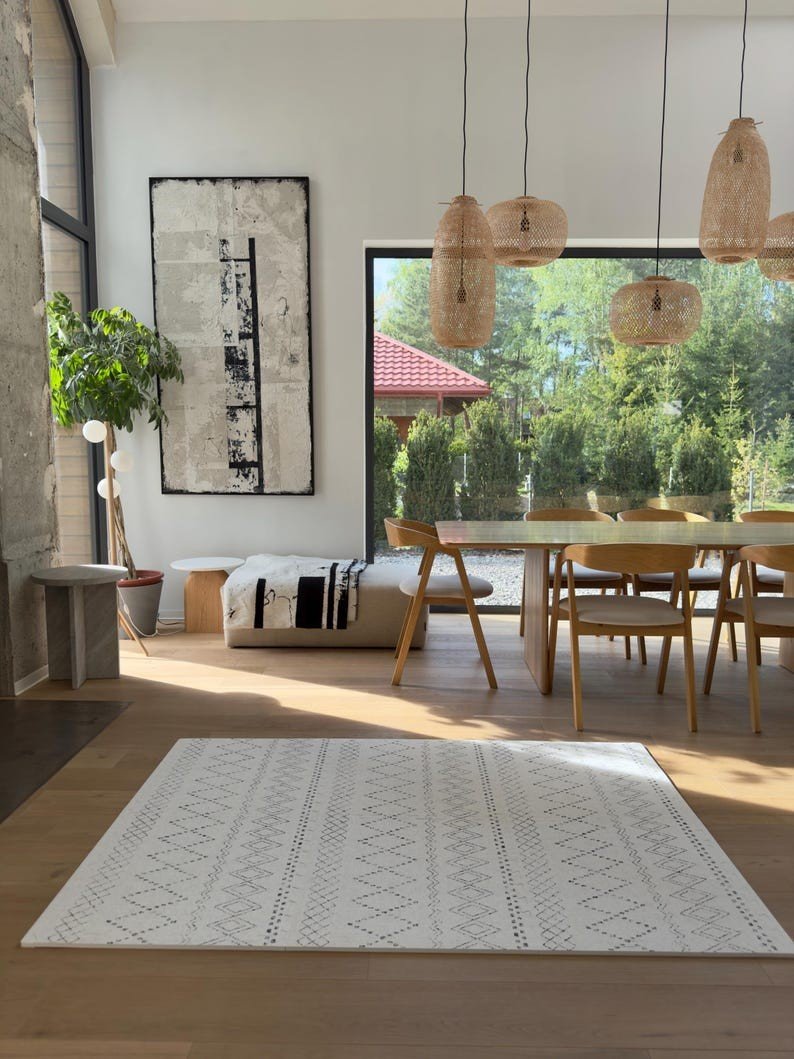 2. Ivory and black boho playmat in stylish dining room with natural light and wooden furniture
