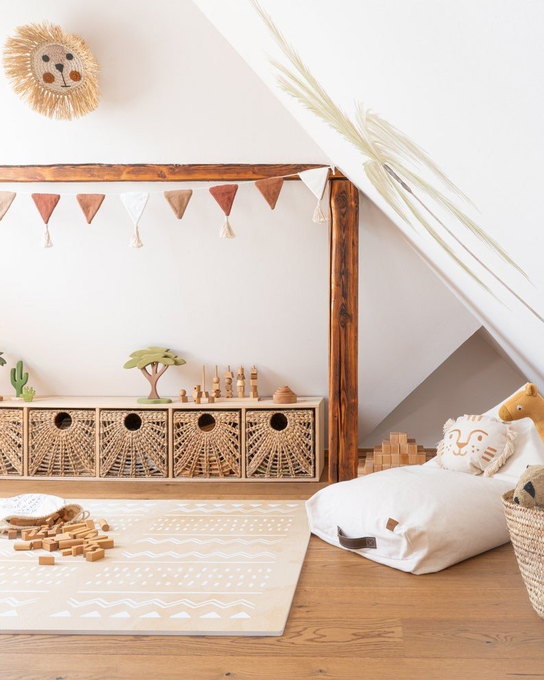 2. Children's play area featuring OLYA KIDS Boho sand puzzle playmat with wooden toys and storage baskets