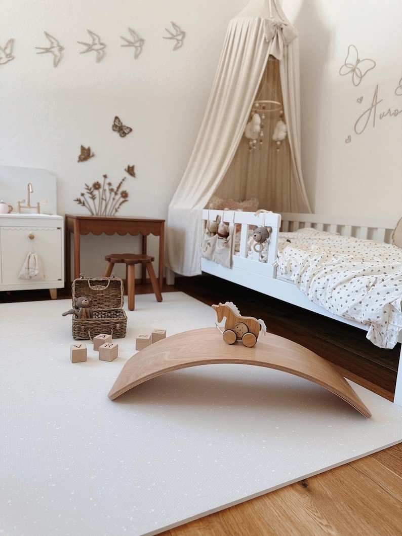 1. Minimalist nursery with OLYA KIDS cashmere spots playmat, wooden toys, and canopy bed