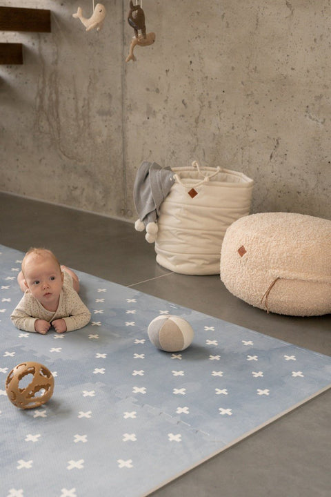 1. Baby on tummy on OLYA KIDS Cross Azure foam puzzle playmat with toys in cozy room