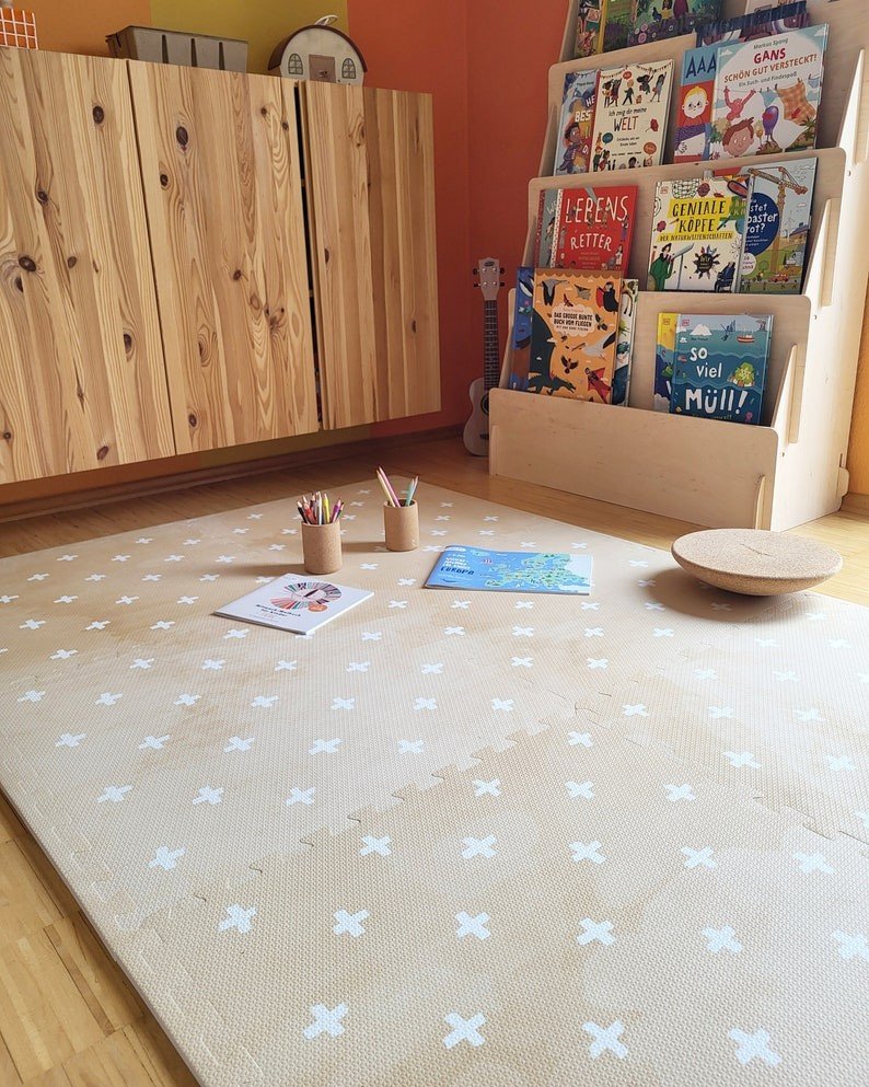8. OLYA KIDS Cross sand foam puzzle playmat in children's room with books and wooden furniture
