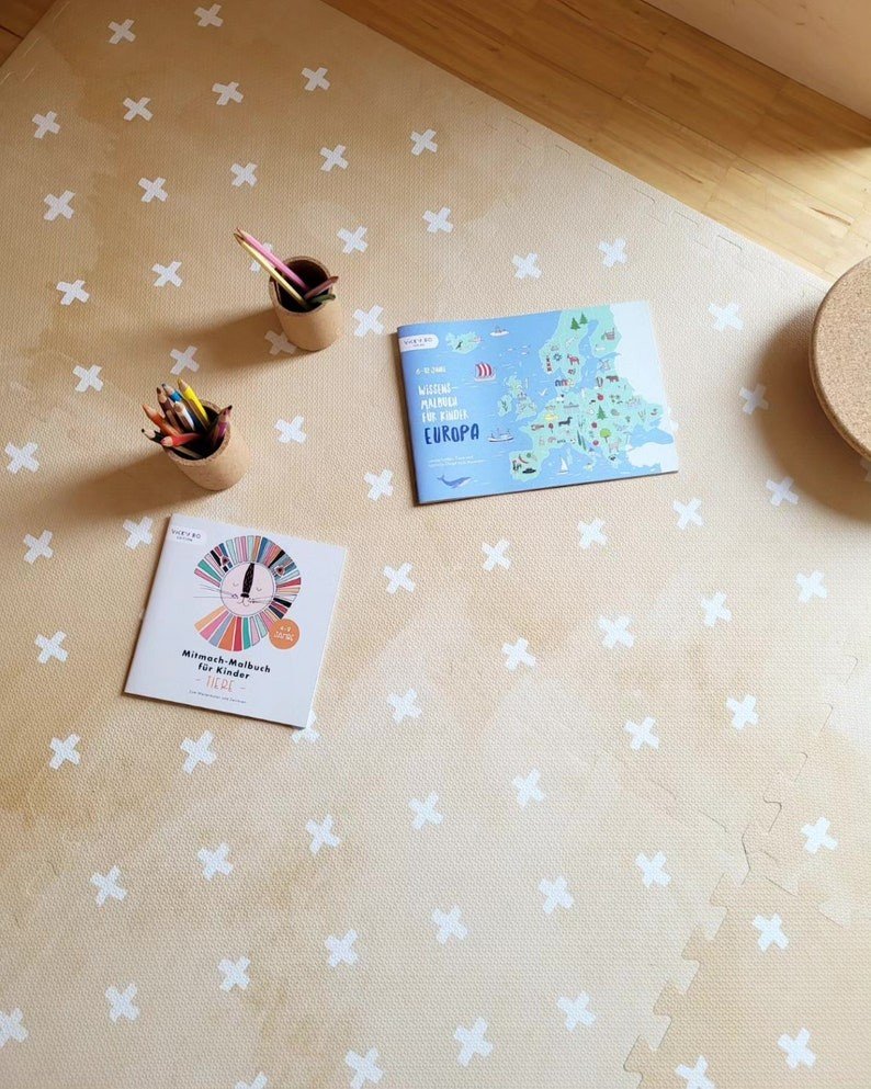 6. OLYA KIDS Cross sand foam puzzle playmat with coloring books and pencils on wooden floor