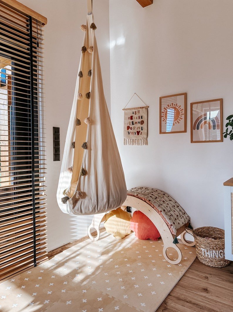 7. Playroom with hanging chair and OLYA KIDS Cross sand foam puzzle playmat on floor