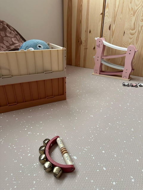 5. Close-up of cappuccino foam puzzle playmat with tambourine and wooden toys