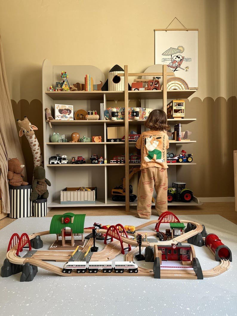 1. Child playing in room with foam puzzle playmat in dove color, surrounded by toys and shelves