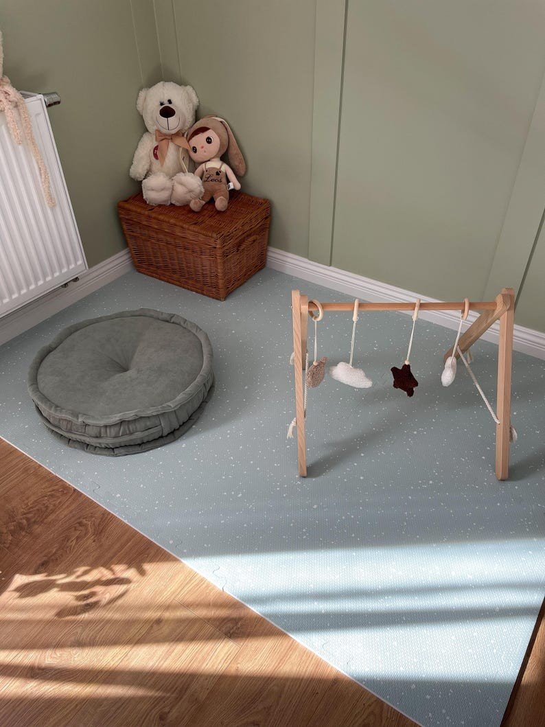5. Olive foam puzzle playmat in nursery with wooden toy gym and plush toys