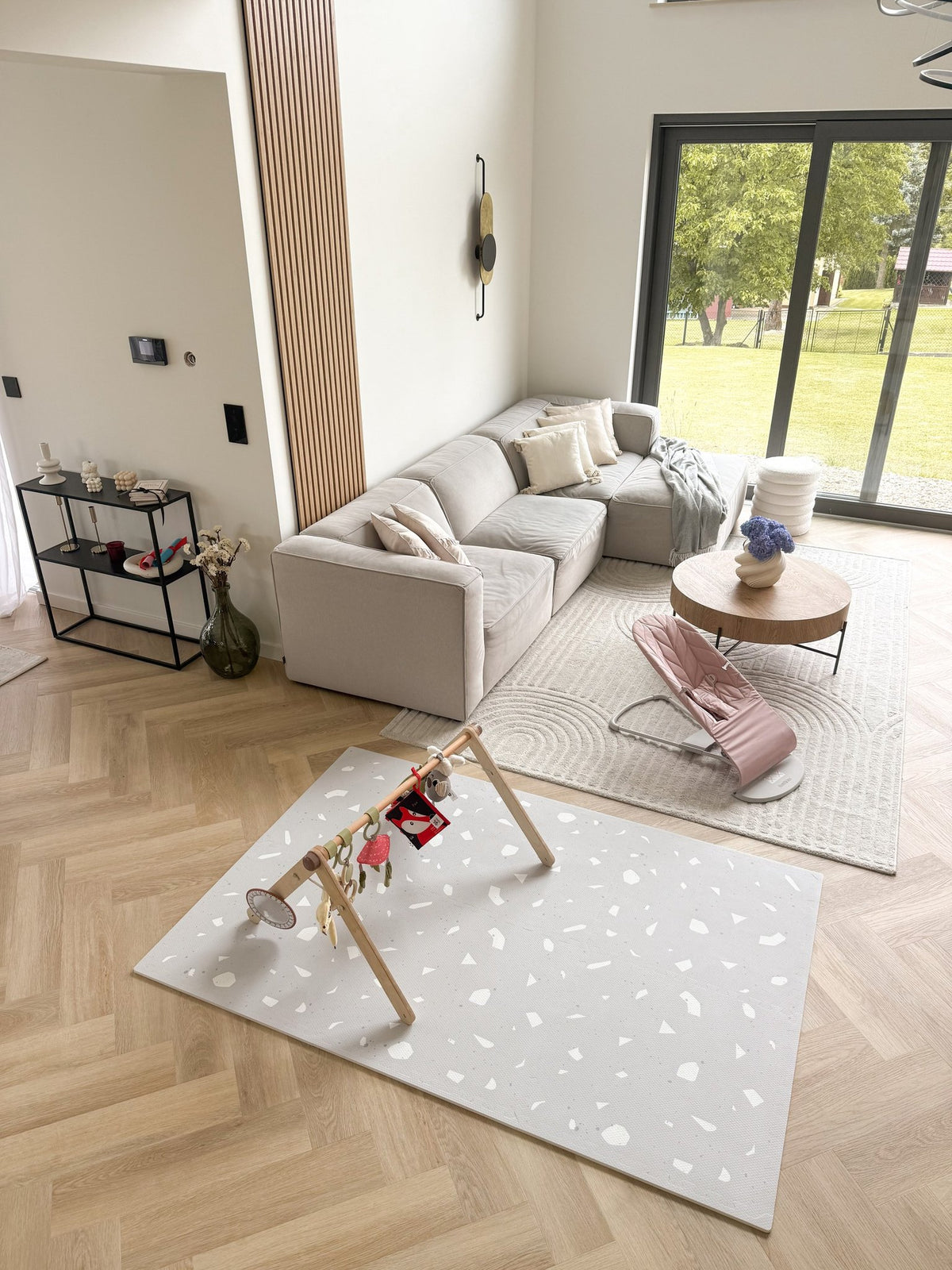 6. Modern living room featuring lavender terrazzo playmat and baby items