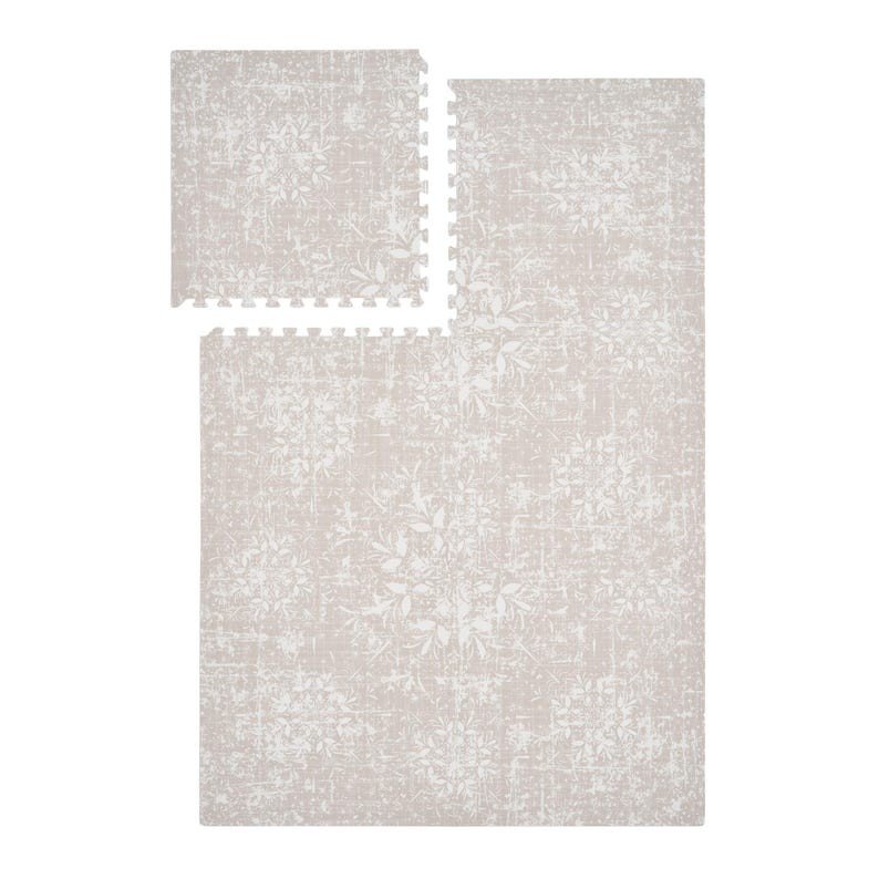 2. Studio shot of vintage beige foam puzzle playmat with floral design, showing one assembled and one separate piece