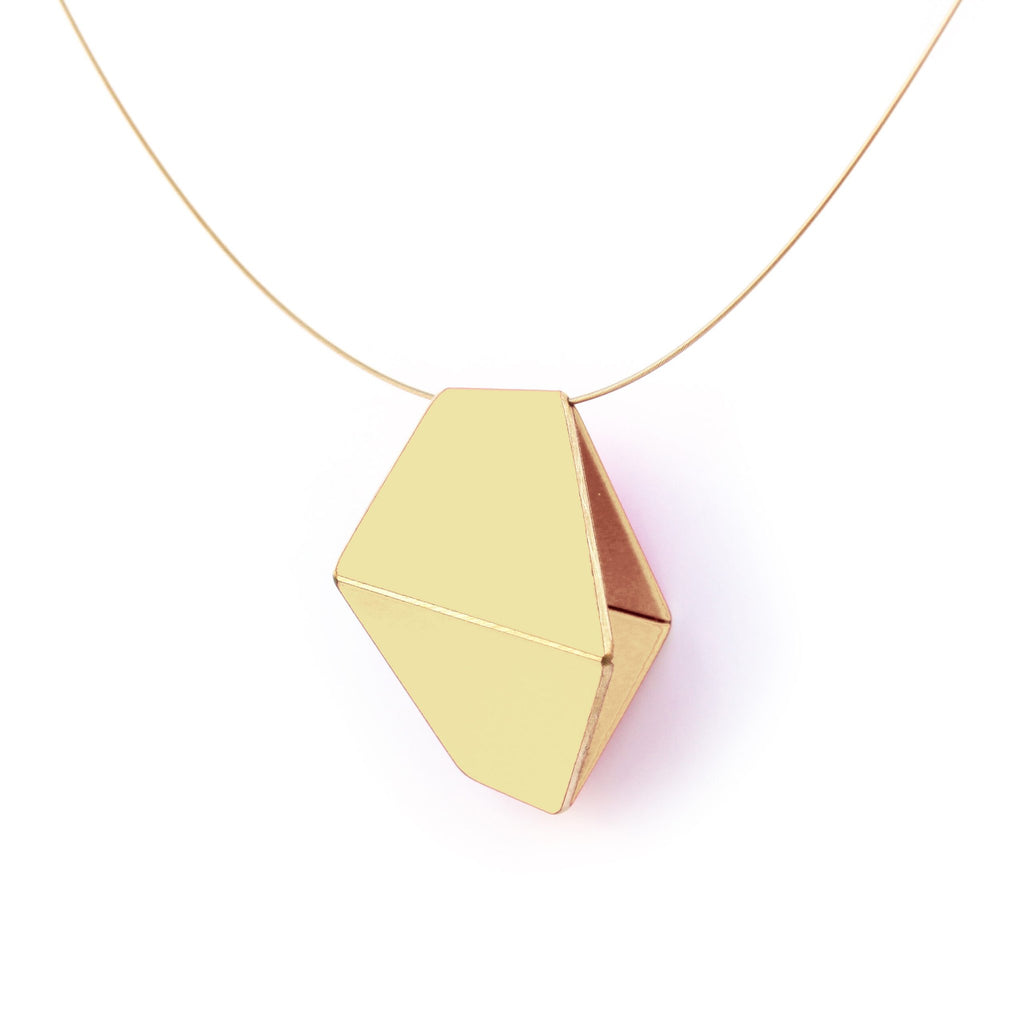 3. Close-up of Lisa Kroeber Jewellery Folded Necklace in ivory, highlighting geometric design and brass material