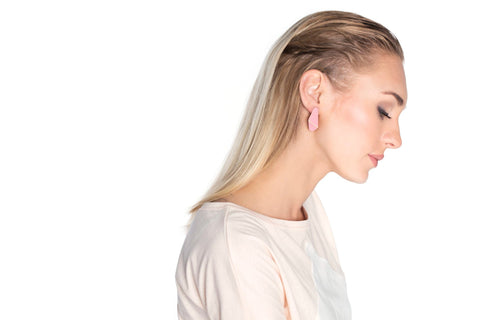 1. Woman wearing Lisa Kroeber Jewellery Folded Slim Earrings in pink, side profile