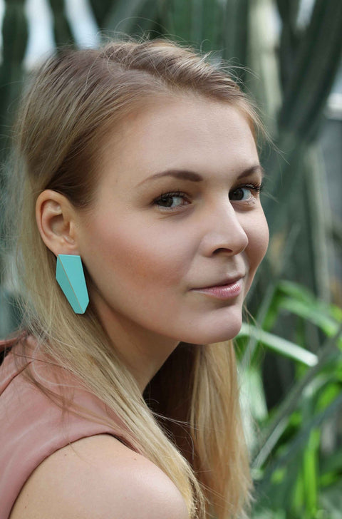 1. Woman wearing Lisa Kroeber Jewellery Folded Vertical Earrings in turquoise, lifestyle setting