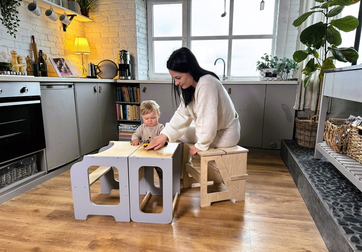 1. Woman and child using wooden folding seat and climbing helper as play table in kitchen