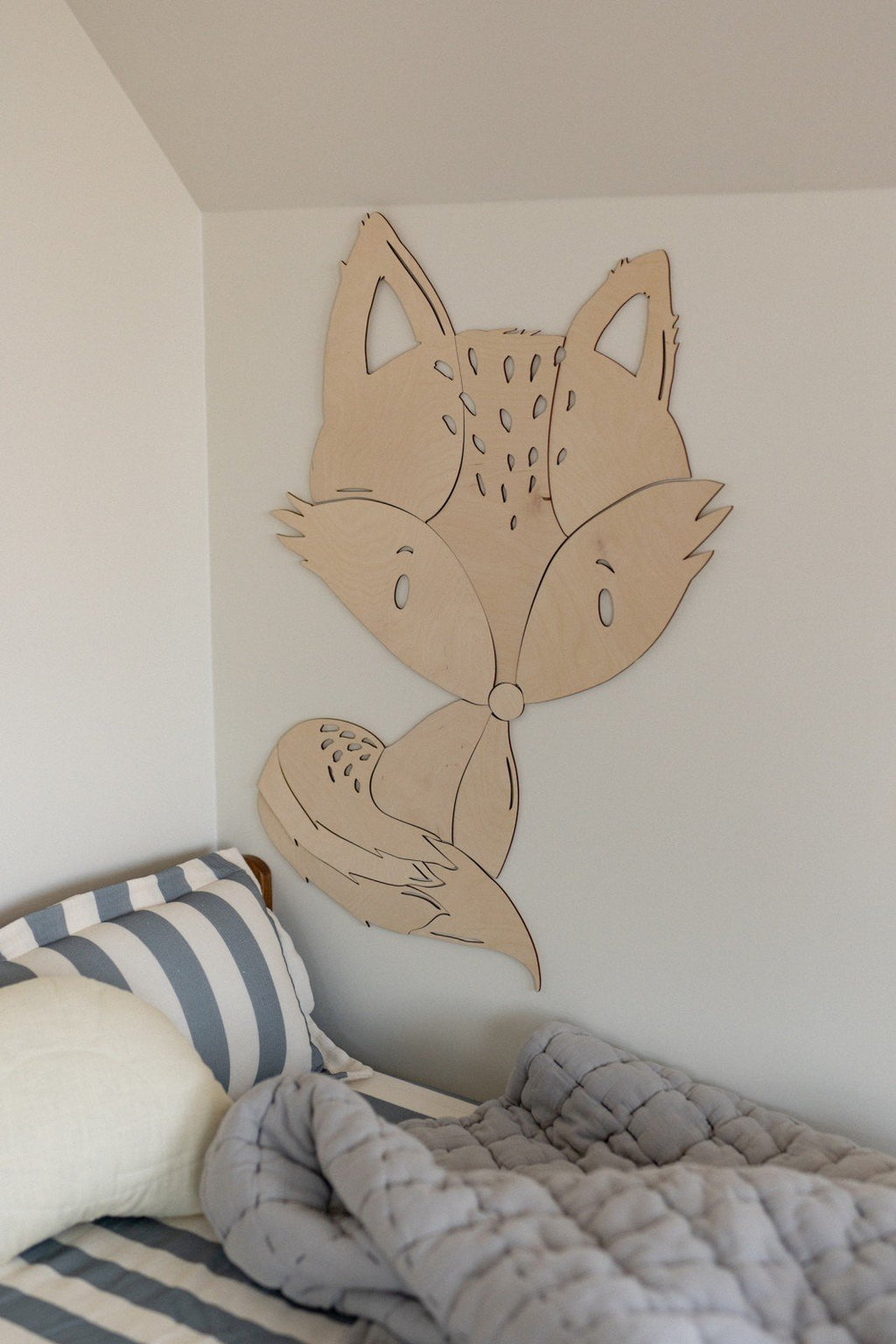2. Fox wooden wall decoration above bed with striped bedding in children's room