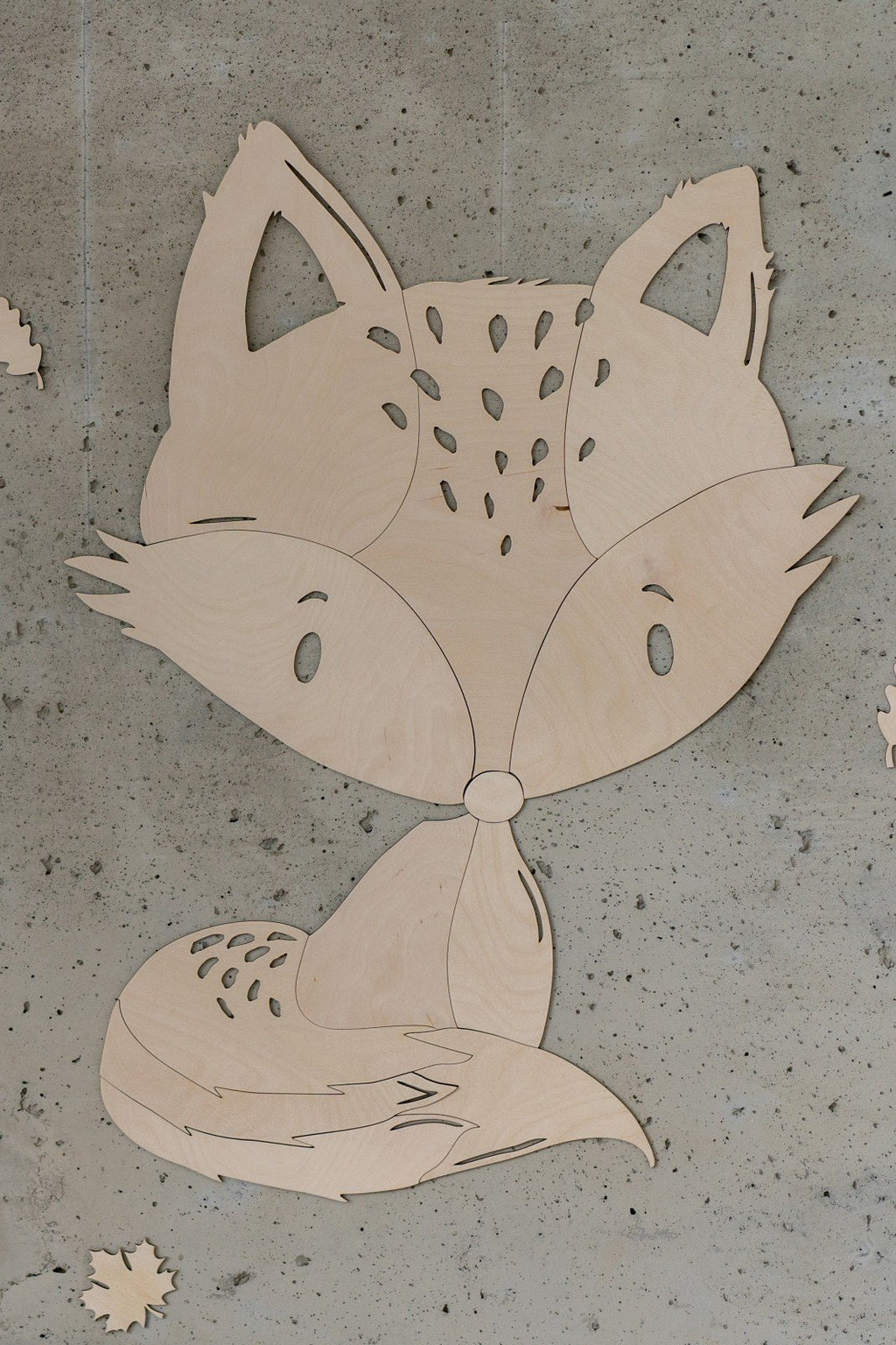 10. Close-up of fox wooden wall decoration on concrete wall with leaf accents