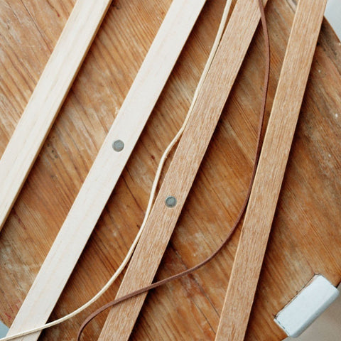 2. Close-up of Terra Mamma oak wood frame pieces with magnetic connectors on a wooden surface
