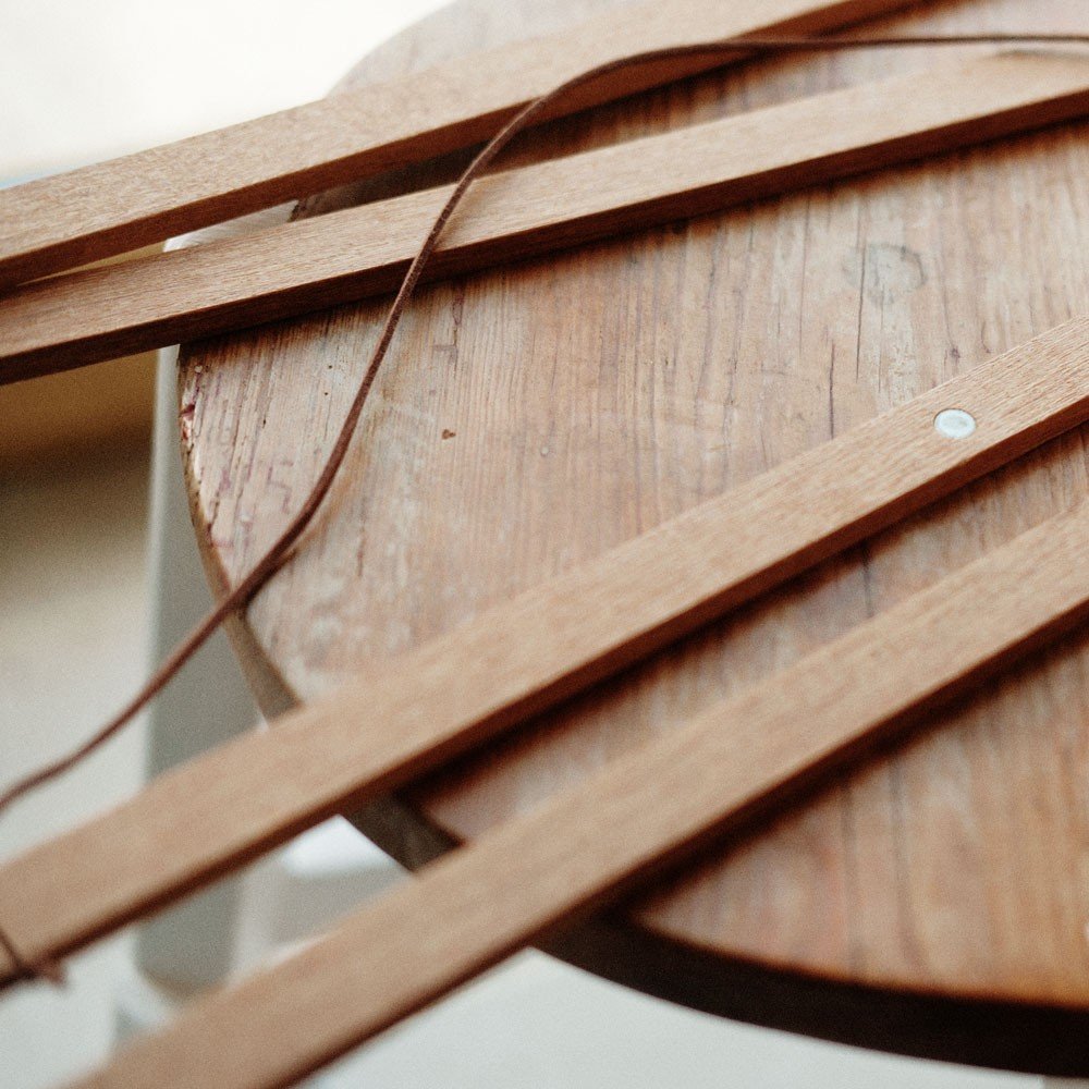 6. Terra Mamma oak wood frame pieces on a wooden stool, emphasizing natural texture and magnetic feature