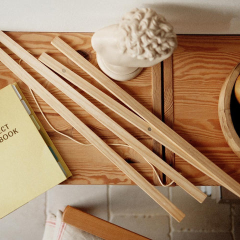 3. Pine wood frame pieces on a wooden table with a decorative bust and notebook, emphasizing elegant decor integration