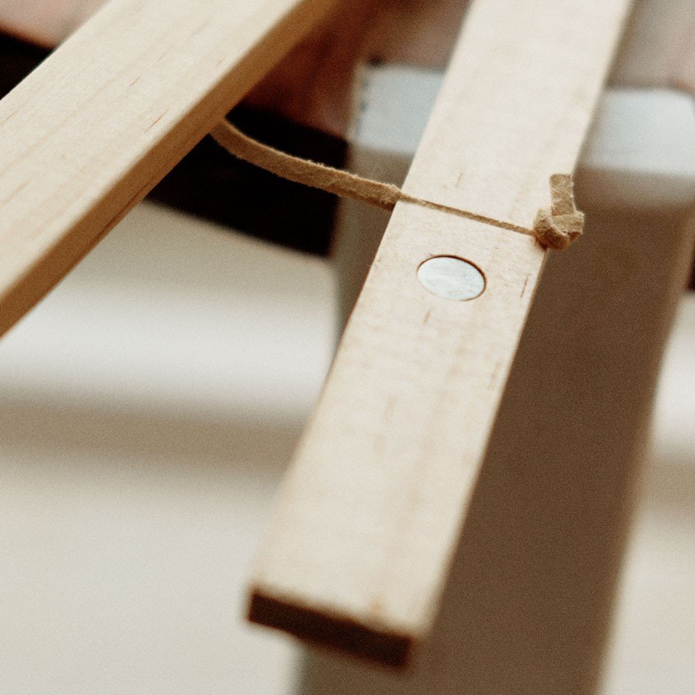 2. Close-up of pine wood frame with visible magnet and string, highlighting craftsmanship and material