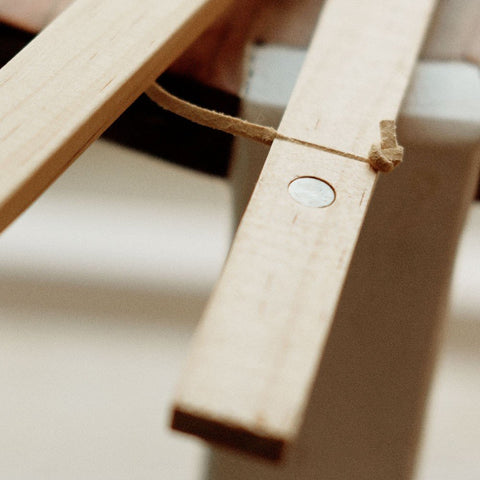 2. Close-up of pine wood frame with visible magnet and string, highlighting craftsmanship and material