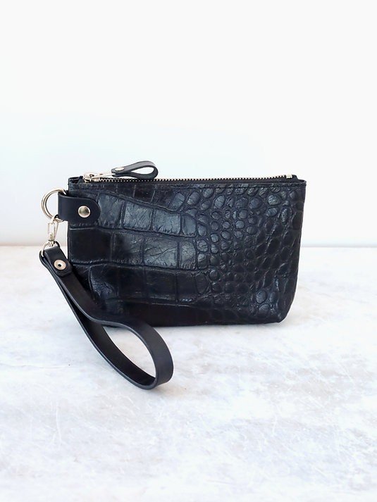9. Black alligator leather POUCH wallet with wrist strap standing on light surface