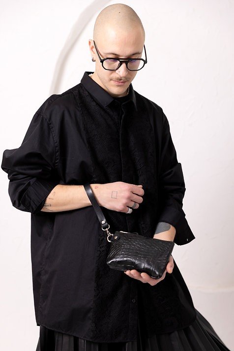 3. Person in black outfit holding black alligator leather POUCH wallet with wrist strap