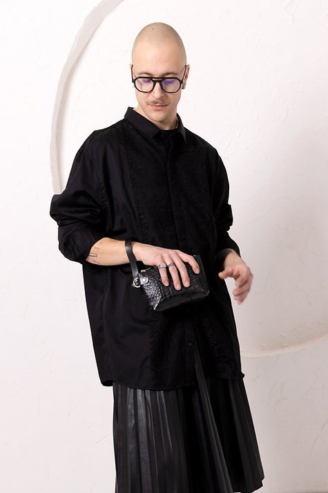 4. Person wearing black clothing holding black alligator leather POUCH wallet with wrist strap