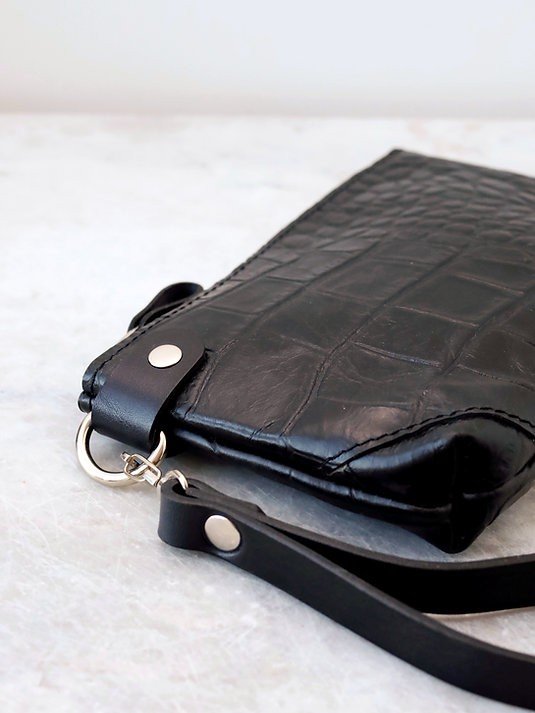 8. Close-up of black alligator leather POUCH wallet highlighting texture and wrist strap