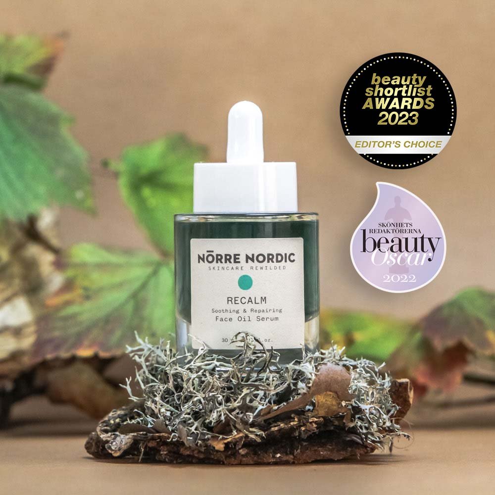 1. Nörre Nordic RECALM Soothing & Repairing Face Oil Serum with awards, shown in natural setting