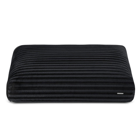2. Black ribbed dog cushion by Labbvenn in studio setting, showcasing plush texture and sleek design