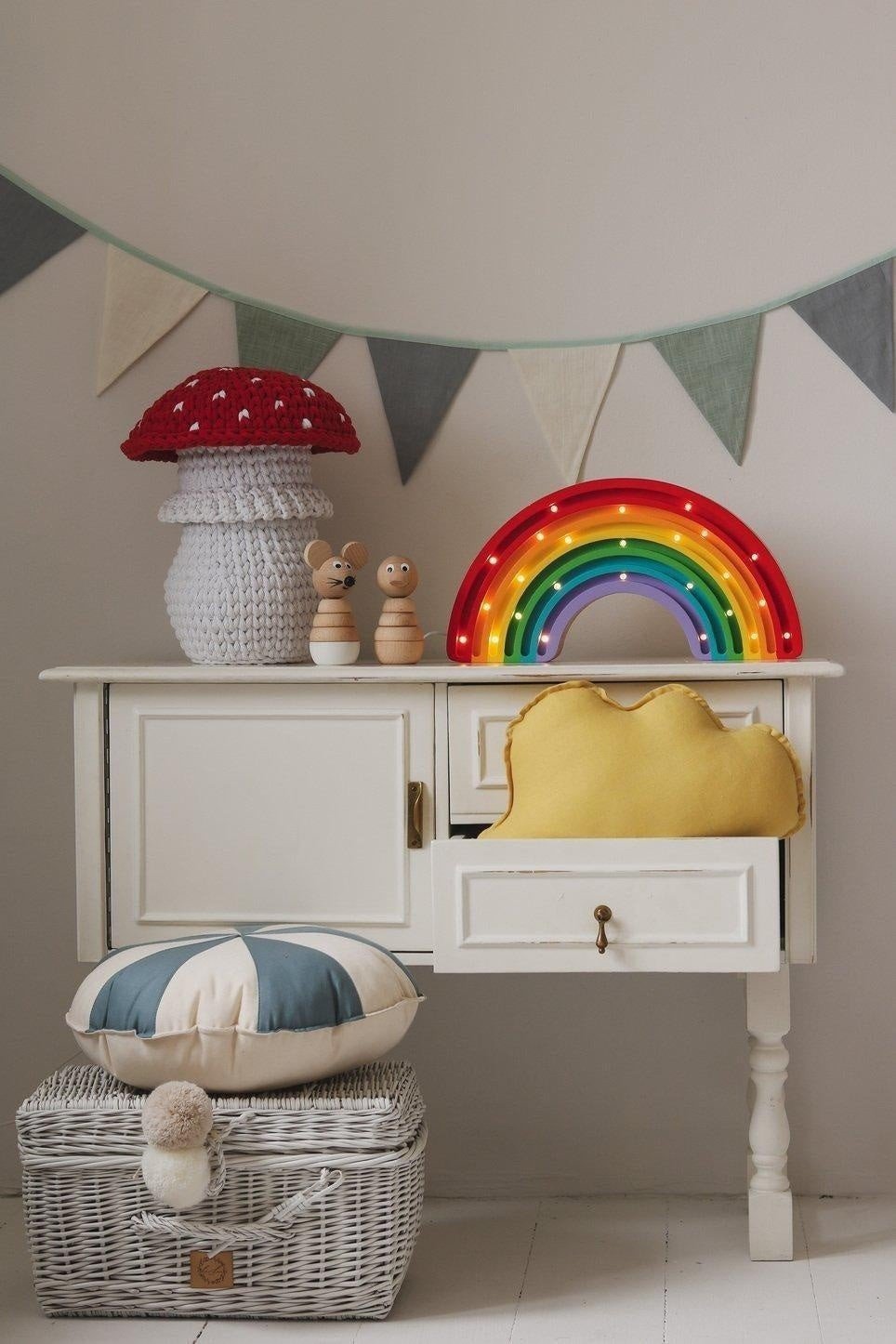 1. Playroom with rainbow light, mushroom decor, and cream, grey, and teal garland hanging above