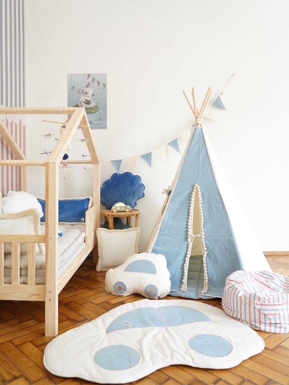 8. Child's room with wooden bed, blue and white teepee, and matching garland