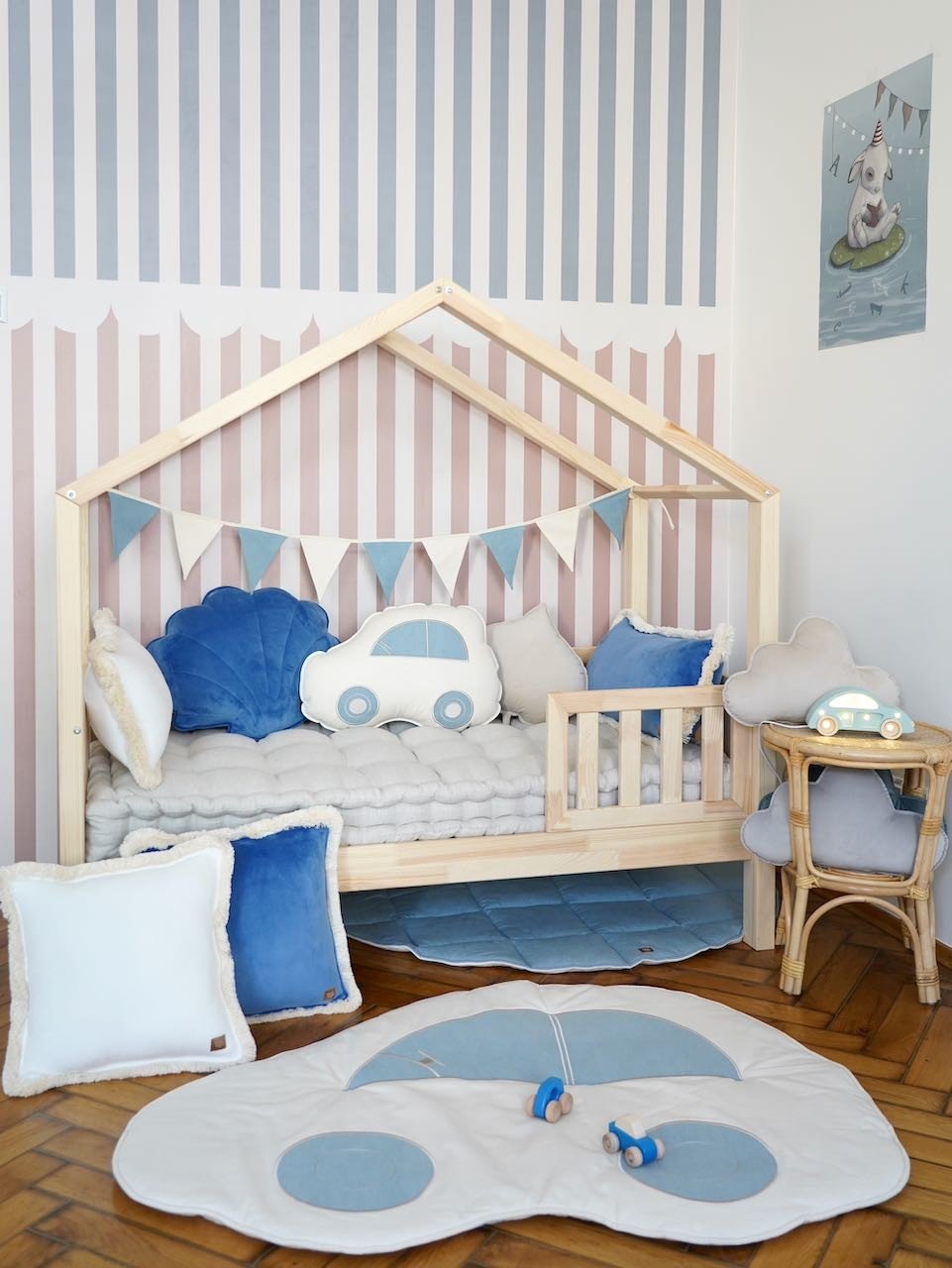 11. Child's room with wooden bed, blue and white garland, and car-themed decor