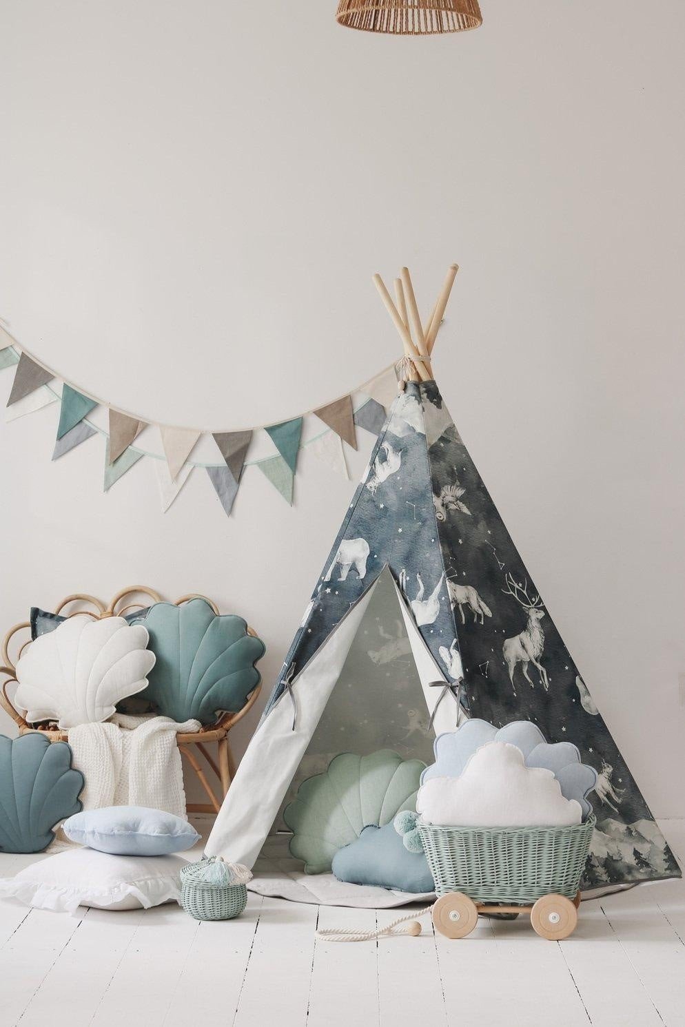1. Children's room with a tepee, shell-shaped cushions, and a mint, white, and grey garland hanging on the wall