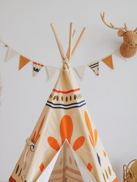 4. Close-up of teepee with orange and blue geometric print and Moi Mili Native Vibe garland on wall