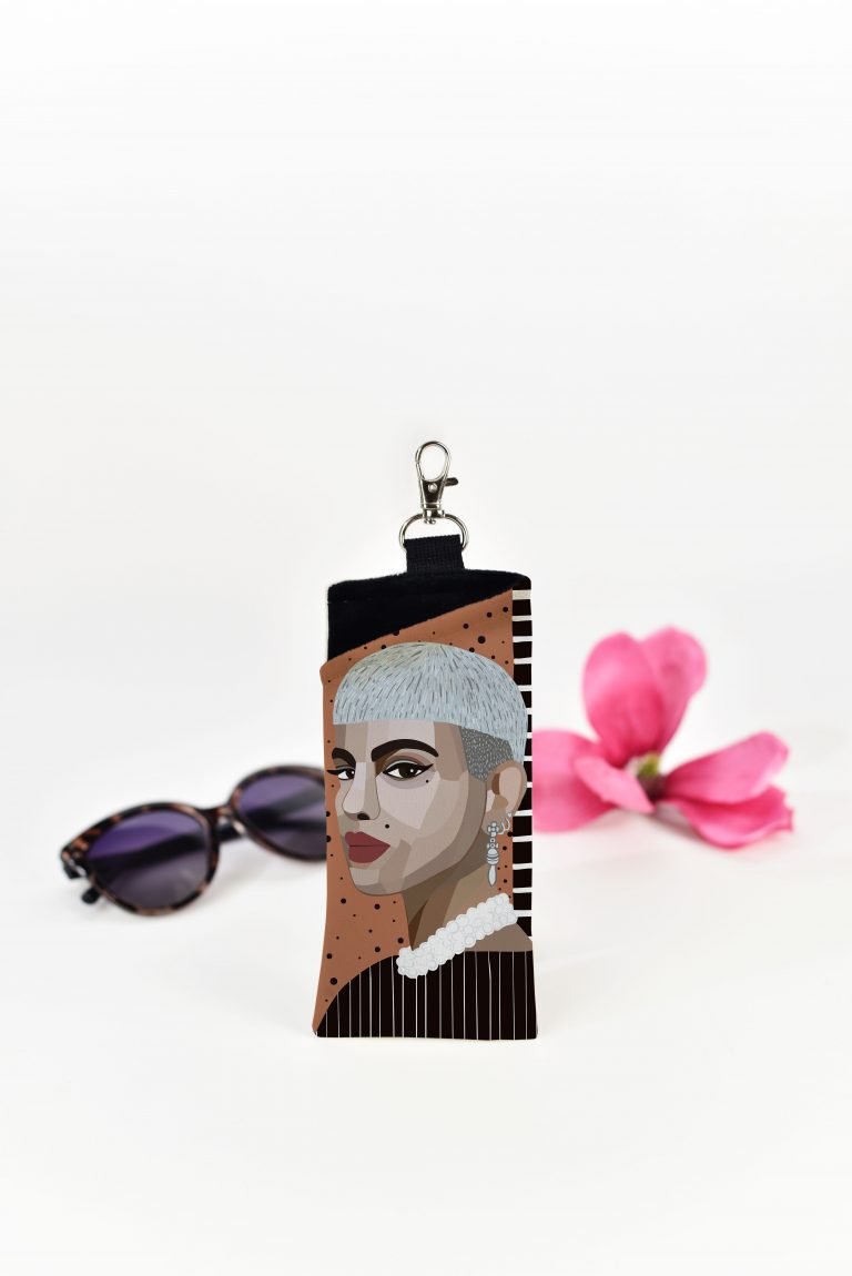 1. Garbanota EYEGLASS CASE ROXY with unique artistic print by Dovilė Aleksonė, shown in lifestyle setting with sunglasses and pink flower